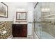 Bathroom with mosaic tile accents, modern lighting, and glass-enclosed shower at 930 Reed Ct, Lakewood, CO 80214