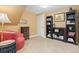 Cozy bedroom showcasing a comfortable chair, shelving, and a side table at 930 Reed Ct, Lakewood, CO 80214
