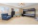 Spacious bedroom with a bunk bed, chair, and plenty of room for play at 930 Reed Ct, Lakewood, CO 80214