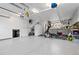 Spacious garage area with fitness equipment and organized tool storage, offering both functionality and convenience at 930 Reed Ct, Lakewood, CO 80214