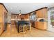 Gourmet kitchen with granite countertops, custom cabinets, stainless steel appliances, and a center island with seating at 930 Reed Ct, Lakewood, CO 80214