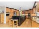 Bright kitchen featuring wooden cabinets, granite countertops, stainless steel appliances, and central island at 930 Reed Ct, Lakewood, CO 80214