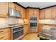 Modern kitchen featuring granite countertops, stainless steel appliances, custom cabinets, and hardwood floors at 930 Reed Ct, Lakewood, CO 80214