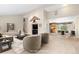 Staged living room featuring an open floor plan, neutral tones, and an adjacent dining and kitchen area at 930 Reed Ct, Lakewood, CO 80214