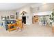 Cozy living room featuring a rocking chair, carpet, and view of kitchen and dining area at 930 Reed Ct, Lakewood, CO 80214