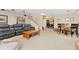 Spacious living area with leather furniture, a wood coffee table, and a staircase at 930 Reed Ct, Lakewood, CO 80214