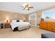 Relaxing main bedroom featuring neutral tones and a ceiling fan at 930 Reed Ct, Lakewood, CO 80214