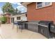 Outdoor kitchen with built in grill, countertop and outdoor seating at 930 Reed Ct, Lakewood, CO 80214