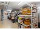 Organized storage room with shelving units featuring ample space for household items and clear plastic storage containers at 930 Reed Ct, Lakewood, CO 80214