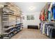 Well-organized walk-in closet with shelving and a bench, providing ample storage at 930 Reed Ct, Lakewood, CO 80214