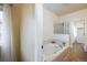 Bathroom featuring a large soaking tub with a shower and tile surround, providing a relaxing spa-like experience at 1122 Olympia Ave # 12H, Longmont, CO 80504