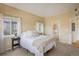 Bright bedroom with neutral tones, plush carpet, and modern furnishings; filled with natural light from two windows at 1122 Olympia Ave # 12H, Longmont, CO 80504
