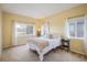 Bright bedroom with neutral walls, comfortable furnishings, and natural light streaming through the windows at 1122 Olympia Ave # 12H, Longmont, CO 80504