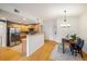 Dining area and kitchen showing stainless steel appliances and modern lighting at 1122 Olympia Ave # 12H, Longmont, CO 80504