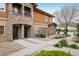 Elegant townhome exterior showcasing stone and siding, inviting entryways, and manicured landscaping at 1122 Olympia Ave # 12H, Longmont, CO 80504
