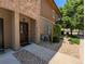 Inviting home entrance with a charming brown door, stone accents, and well-maintained landscaping at 1122 Olympia Ave # 12H, Longmont, CO 80504