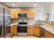 Functional kitchen boasts stainless steel appliances, wood cabinetry, and a practical layout at 1122 Olympia Ave # 12H, Longmont, CO 80504