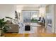 Bright living room featuring hardwood floors, a cozy fireplace, and sliding doors to the balcony at 1122 Olympia Ave # 12H, Longmont, CO 80504