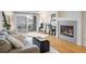 Living room showcasing wood floors, fireplace, and sliding glass doors to balcony at 1122 Olympia Ave # 12H, Longmont, CO 80504