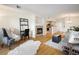 Open-concept living room with a fireplace and view into the kitchen and dining area at 1122 Olympia Ave # 12H, Longmont, CO 80504