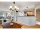 Bright open-concept living room and kitchen with hardwood floors and fireplace at 1122 Olympia Ave # 12H, Longmont, CO 80504