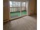 A sliding door opens to a patio with privacy elements at 750 S Alton Way # 8C, Denver, CO 80247