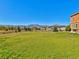 Expansive green backyard offering serene views and privacy, enclosed by a charming wooden fence at 1235 Woodmoor Acres Dr, Monument, CO 80132
