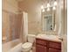 Standard bathroom includes shower-tub combo with tile surround and single sink vanity at 1235 Woodmoor Acres Dr, Monument, CO 80132