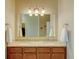 Elegant bathroom with double vanity, granite countertops, and a large mirror at 1235 Woodmoor Acres Dr, Monument, CO 80132