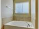 Close up of a bathtub, with tile surround and chrome fixtures at 1235 Woodmoor Acres Dr, Monument, CO 80132