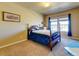 Bedroom with carpet, double window with blinds, and wood four-poster bed at 1235 Woodmoor Acres Dr, Monument, CO 80132