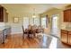 Elegant dining room featuring hardwood floors, a wooden table, and an ornate chandelier at 1235 Woodmoor Acres Dr, Monument, CO 80132