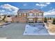 Two-story house with a three-car garage and a partially snow-covered front yard at 1235 Woodmoor Acres Dr, Monument, CO 80132