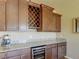 Kitchen wet bar with wine rack and granite countertop at 1235 Woodmoor Acres Dr, Monument, CO 80132