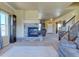 Inviting living room with stone fireplace, grandfather clock, and staircase at 1235 Woodmoor Acres Dr, Monument, CO 80132