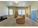 Bright living room with neutral carpet, comfortable seating, and large windows at 1235 Woodmoor Acres Dr, Monument, CO 80132