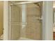 Shower with glass enclosure and tile surround at 1235 Woodmoor Acres Dr, Monument, CO 80132