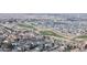 Expansive aerial view of a well-planned community nestled around a green golf course at 17926 E 104Th Way # C, Commerce City, CO 80022