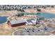 Aerial view of the community center and playground, located near the pond, showing amenities for residents at 17926 E 104Th Way # C, Commerce City, CO 80022