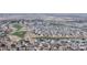 High-angle aerial showcases a community's layout near the fairways and greens of the golf course at 17926 E 104Th Way # C, Commerce City, CO 80022