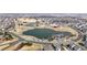 Wide aerial perspective showcasing the pond, community center, playground, and surrounding homes at 17926 E 104Th Way # C, Commerce City, CO 80022