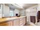 Bathroom featuring dual sinks, spacious countertop, and glass-enclosed shower at 17926 E 104Th Way # C, Commerce City, CO 80022