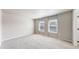 This bedroom offers neutral color palette, with multiple windows and carpet flooring at 17926 E 104Th Way # C, Commerce City, CO 80022