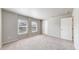 Spacious bedroom with neutral carpet, two windows, and white trim throughout at 17926 E 104Th Way # C, Commerce City, CO 80022