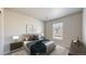 This bedroom boasts a neutral color scheme, soft carpet, and a large window for natural light at 17926 E 104Th Way # C, Commerce City, CO 80022