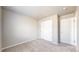 This room has plush carpeting, a closet, and two doors at 17926 E 104Th Way # C, Commerce City, CO 80022
