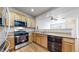Functional kitchen with stainless steel appliances, granite countertops, and hardwood flooring at 17926 E 104Th Way # C, Commerce City, CO 80022