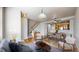 Open-concept living and dining area with hardwood floors, a staircase, and a view into the kitchen at 17926 E 104Th Way # C, Commerce City, CO 80022