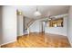 Bright living area with hardwood floors, staircase access, and a view of the adjacent kitchen at 17926 E 104Th Way # C, Commerce City, CO 80022