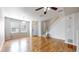 Bright living room with hardwood floors and staircase access, offering a clean and modern aesthetic at 17926 E 104Th Way # C, Commerce City, CO 80022
